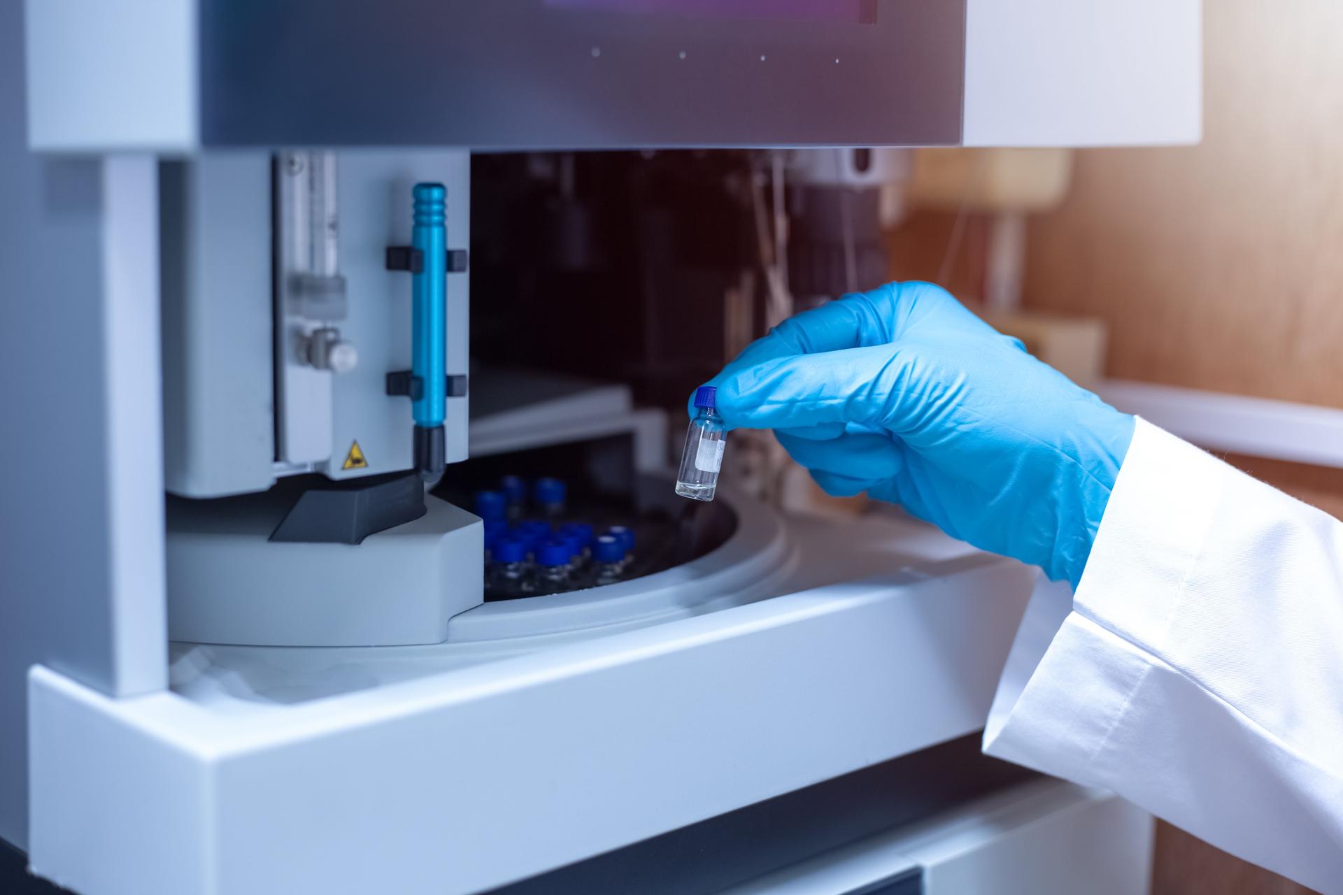 Scientist moved the vial of sample out from the tray autosampler of the Liquid Chromatography Mass Spectrometer LC/MS
